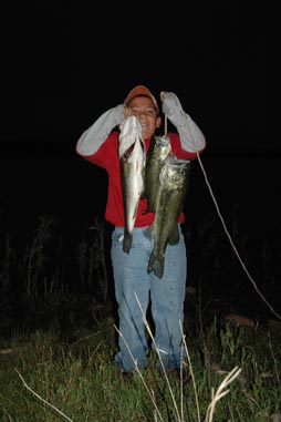 Child posing with fish he caught.