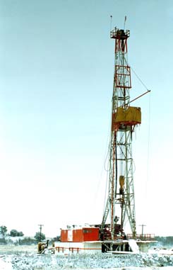 Oil drilling rig in snowy field at McKnight Ranch